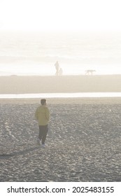 Man Walking On Hazy Beach