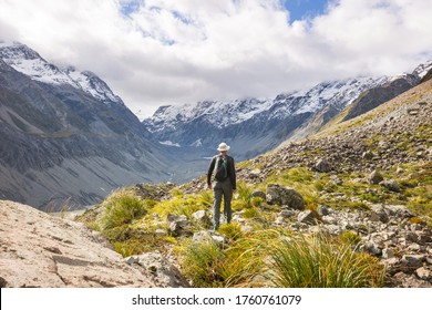 Man walking on hike trail route with Mount Cook National Park, beautiful mountains region. Tramping, hiking, travel in New Zealand. - Shutterstock ID 1760761079