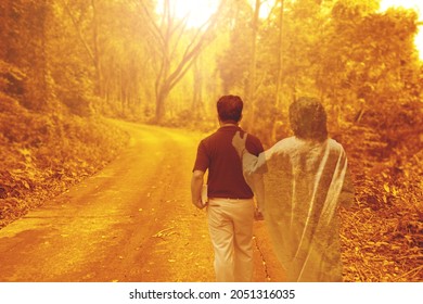 A man is walking on the road with shadow of Jesus Christ. - Shutterstock ID 2051316035