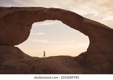 Man walking on rocks in the desert of the wadi rum in jordan at sunset - Powered by Shutterstock