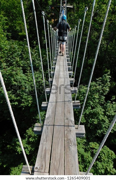 Man walking on rope bridge, Refreshing\
Mountain Camp, Pennsylvania
