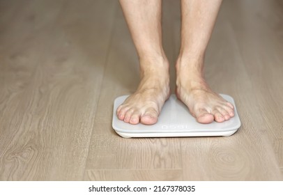 Man Walking On Scales Measure Weight. Male Wal Checking BMI Weight Loss. Human Barefoot Measuring Body Fat Overweight. Guy Legs Step On Bathroom Scale.