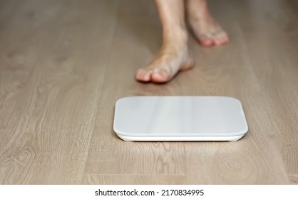 Man Walking On Scales Measure Weight. Male Wal Checking BMI Weight Loss. Human Barefoot Measuring Body Fat Overweight. Guy Legs Step On Bathroom Scale.