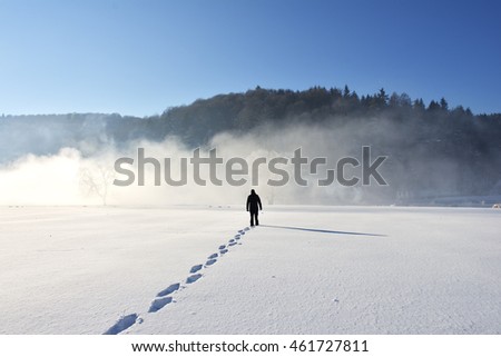 Man walking on snow, footprints in snow, behind