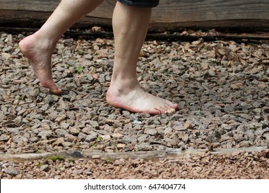Man is walking on texture surface pavement, Reflexology. Barefoot trail. - Shutterstock ID 647404774