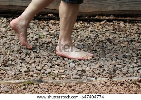 Man is walking on texture surface pavement, Reflexology. Barefoot trail.
