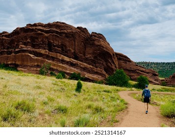 Man walking on trail Red Rocks park in Denver, Colorado - Powered by Shutterstock