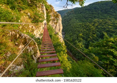 Man Walking On Via Ferrata Trail, Casa Zmeului, Romania, Sunset In A Summer Day