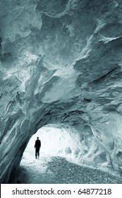 Man Walking Out Of A Cave