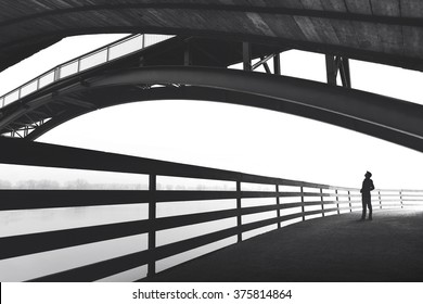 Man Walking Outdoor Under Bridge