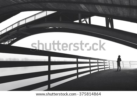 Man walking outdoor under bridge