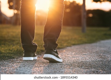 Man walking outdoors in the park at sunset. Man on his way to a new better life. The way forward. New start, new life and freedom concept.