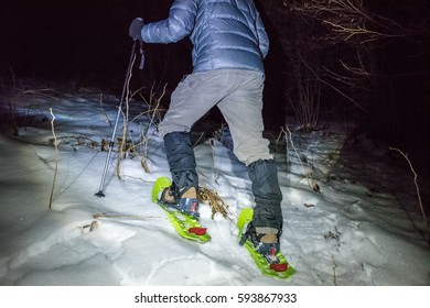 Man Walking Up Snowy Hillside In The Night