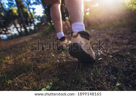 Man walking with sport shoes into nature view from the ground