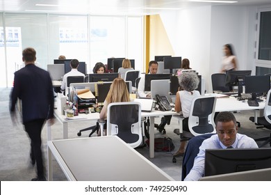 Man walking through a busy open plan office