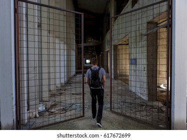 A Man Walking Through The Hallway