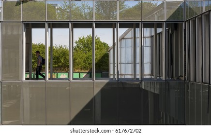 A Man Walking Through The Hallway