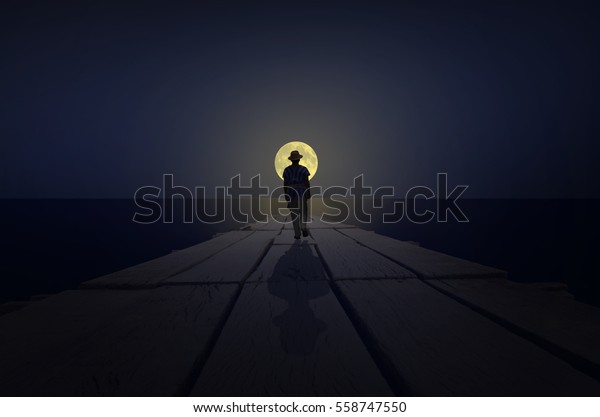 Man walks to the moon at\
night