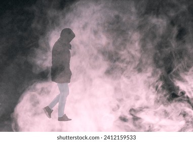 A man walks through a smoke screen