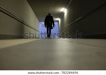 man walks in the underpass