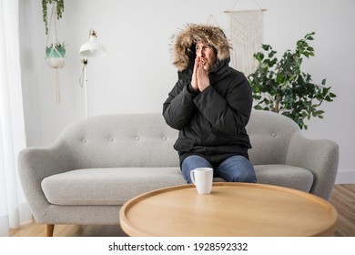 A Man With Warm Clothing Feeling The Cold Inside House On The Sofa