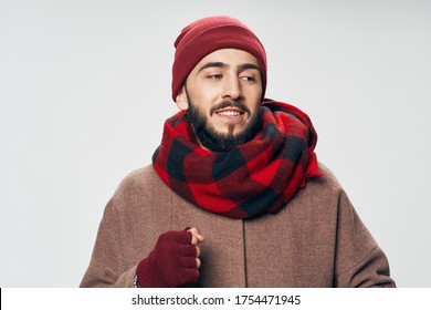 A Man In A Warm Jacket And A Scarf Around His Neck