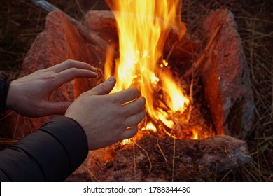 The man warming hands near the bonfire. night cold time. - Powered by Shutterstock