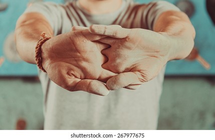 Man warming up his hands before climbing indoor