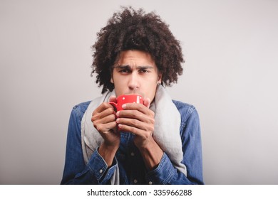 man warming up with hot tea in wintertime