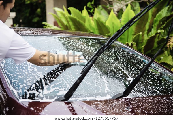 Man wash car using shampoo - every day life car\
care concept
