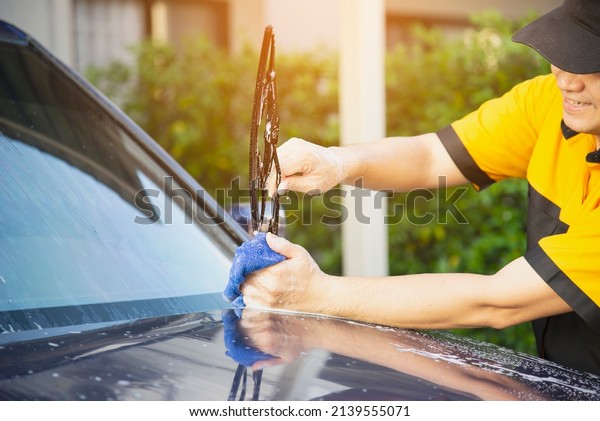 Man wash car using shampoo - every day life car\
care concept