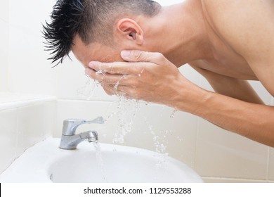 Man Wash Face In Bathroom