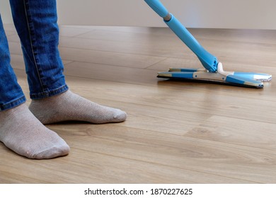 A Man Washes The Floors With A Mop In The Room. Under The Bed. Cleaning.