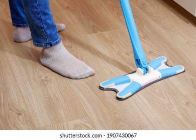 A Man Washes The Floors With A Mop In The Room. Under The Bed. Cleaning.