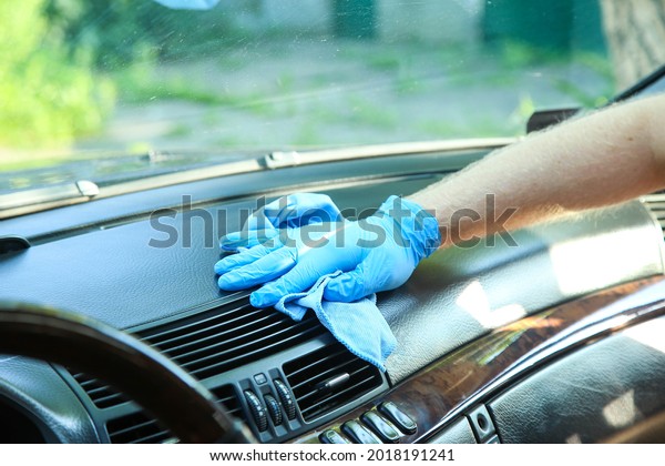 A man washes the\
front panel of the car