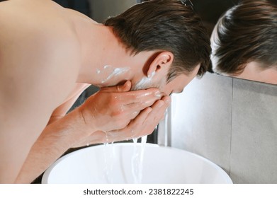 A man washes his face after shaving. - Powered by Shutterstock