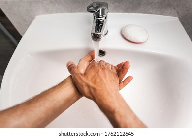 A Man Washes His Hands In The Sink. First Person Photo