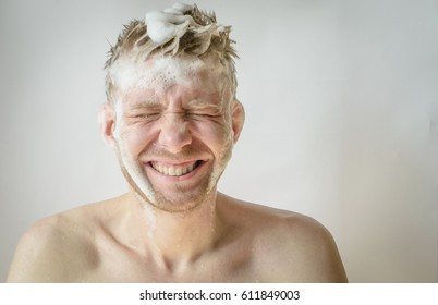 A Man Washes His Head With Shampoo