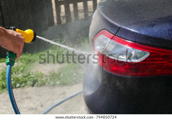  man\
washes,Cleaning Car With Jet\
Sprayer