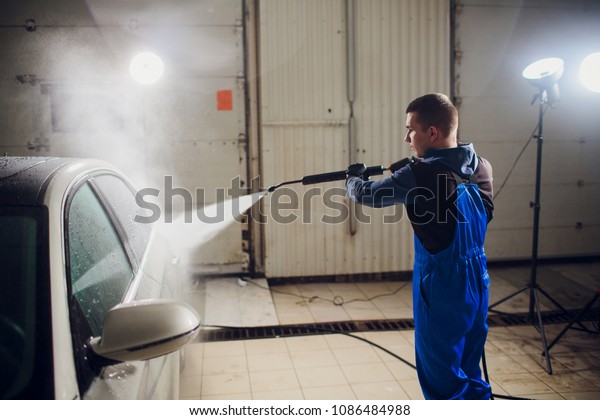 man\
washing automobile manual car washing self service,cleaning with\
foam,pressured water. Transportation care concept. Washing car in\
self service station with high pressure\
blaster