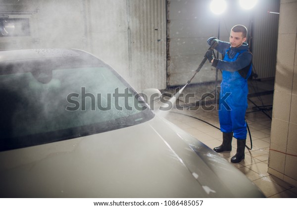 man\
washing automobile manual car washing self service,cleaning with\
foam,pressured water. Transportation care concept. Washing car in\
self service station with high pressure\
blaster