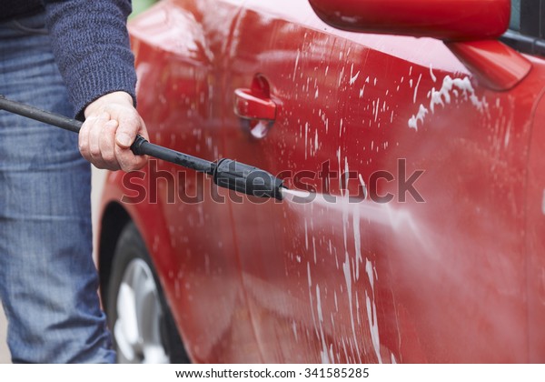 Man Washing Car With\
Pressure Washer