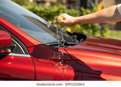 man washing car with soapy sponge - Powered by Shutterstock