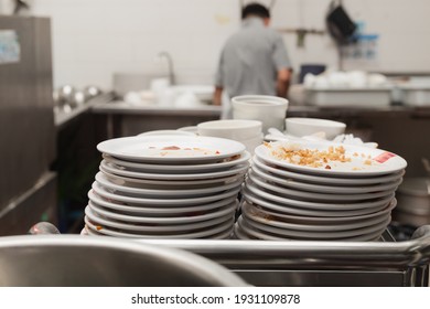 Man Washing Dish In Sink At Restaurant.People Are Washing The Dishes Too Cleaning Solution