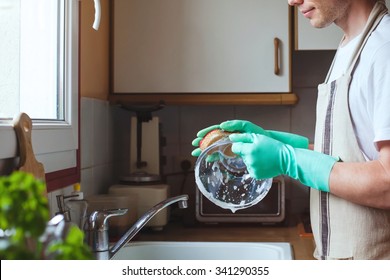 Man Washing Dishes In The Kitchen Sink At Home, Close Up Of Hands With Sponge And Soap, Housework