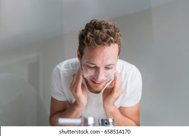 Man Washing Face With Facial Cleanser Face Wash Soap In Bathroom Sink At Home.