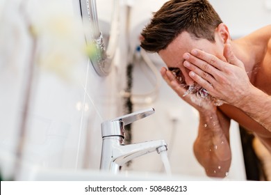 Man Washing Face In Morning And Practicing Hygiene