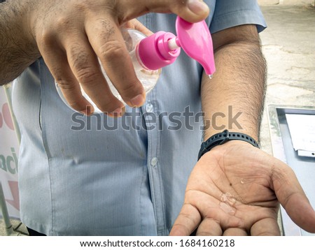 Man washing hands with alcohol gel or antibacterial soap sanitizer after using a public restroom. Hygience concept. Prevent the spread of germs and bacteria and avoid infections corona virus.