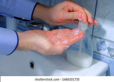 Man Is Washing Hands With Antibacterial Soap In Sink, Hands Closeup. Fighting Spread Of Coronavirus Infection Covid-19. Hygienic Procedures At Home On Quarantine And Isolation During Pandemic. OCD.