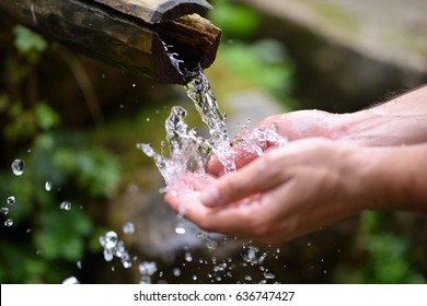 Man Washing Hands In Fresh, Cold, Potable Water Of Mountain Spring